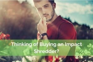 Man in garden thinking of buyinng and impact garden shredder